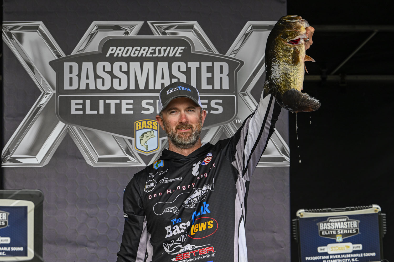 Bryant Smith holding a massive bass on stage